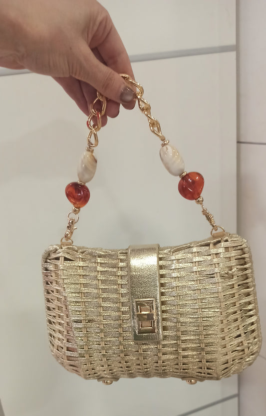 bolso de mano de yute dorado